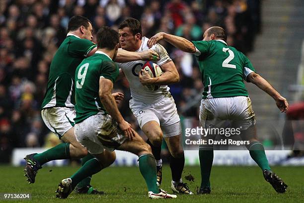 Mark Cueto of England is stopped by Rory Best , Tomas O'Leary and Cian Healy of Ireland during the RBS Six Nations match between England and Ireland...