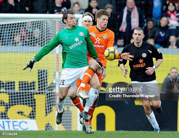 Goalkeeper Heinz Mueller of Mainz battles for the ball with Sebastian Proedl of Bremen during the Bundesliga match between FSV Mainz 05 and SV Werder...