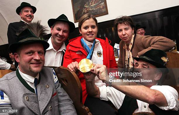 Victoria Rebensburg, Olympic gold medal winner, poses with members of Bavarian dressed brass band during a local reception on February 27, 2010 in...