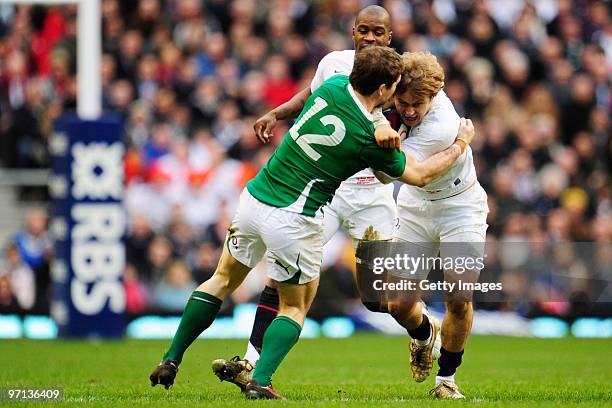 Mathew Tait of England is tackled by Gordon D'Arcy of Ireland during the RBS Six Nations match between England and Ireland at Twickenham Stadium on...