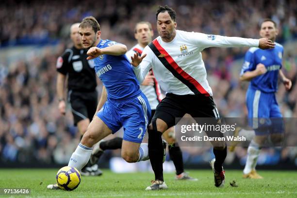 Branislav Ivanovic of Chelsea and Joleon Lescott of Manchester City battle for the ball during the Barclays Premier League match between Chelsea and...