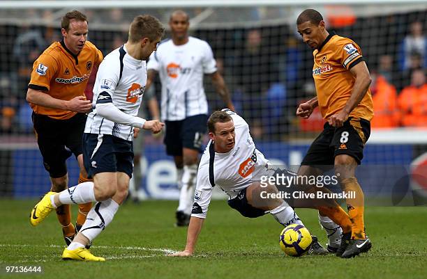 Karl Henry of Wolverhampton Wanderers moves around a grounded Kevin Davies of Bolton Wanderers during the Barclays Premier League match between...