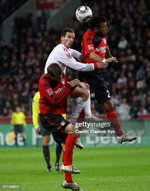 Petit of Koeln vies for a header with Arturo Vidal and Toni Kroos of Leverkusen during the Bundesliga match between Bayer Leverkusen and 1. FC Koeln...