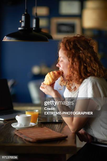 woman in coffee shop - croissant café stock pictures, royalty-free photos & images