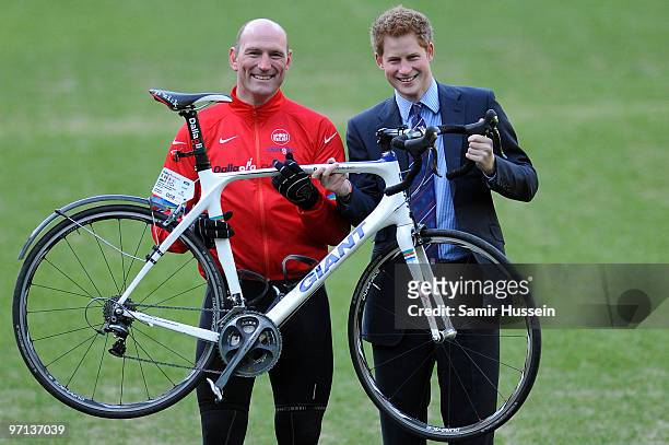 Prince Harry and former England rugby player Lawrence Dallaglio pose at Twickenham Stadium as they welcome back cyclists taking part in the Dallaglio...