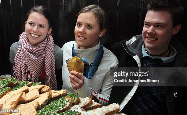 Victoria Rebensburg , Olympic gold medal winner, poses beside of her sister Stephanie and brother Dominik during a local reception on February 27,...