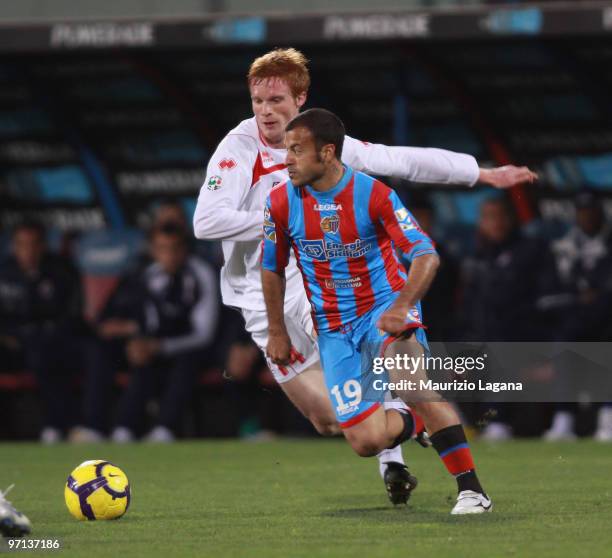 Adrian Ricchiuti of Catania Calcio battles for the ball with Alessandro Gazzi of AS Bari during the Serie A match between Catania and Bari at Stadio...