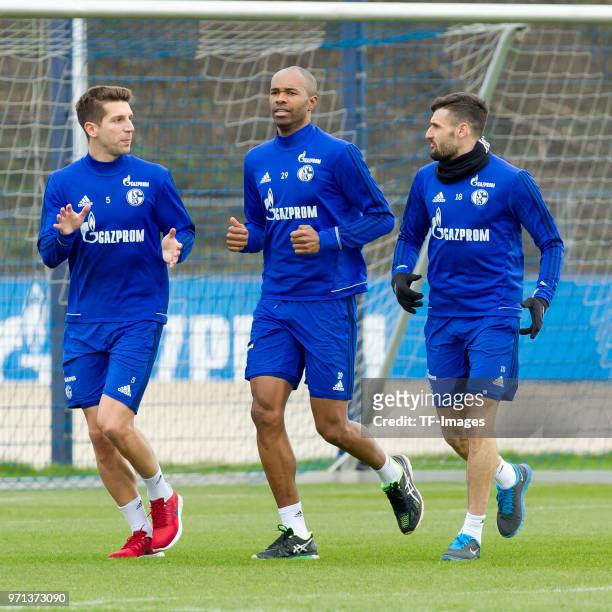 Matija Nastasic of Schalke, Naldo of Schalke and Daniel Caligiuri of Schalke run during a training session at the FC Schalke 04 Training center on...