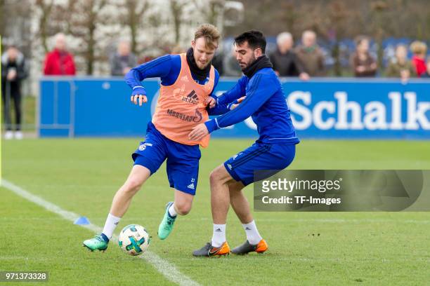 Cedric Teuchert of Schalke and Pablo Insua of Schalke battle for the ball during a training session at the FC Schalke 04 Training center on April 3,...