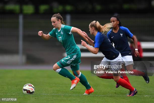 Anna Weib of U20 Women's Germany is challenged by Pauline Dechillyd of U20 Women's France during the Four Nations Tournament match between U20...