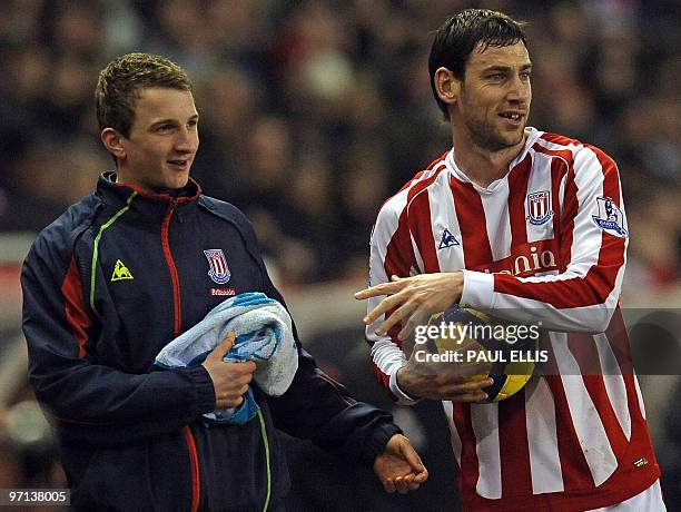 Stoke City's Irish midfielder Rory Delap cleans the ball with the help of a ball boy during the English Premier League football match between Stoke...
