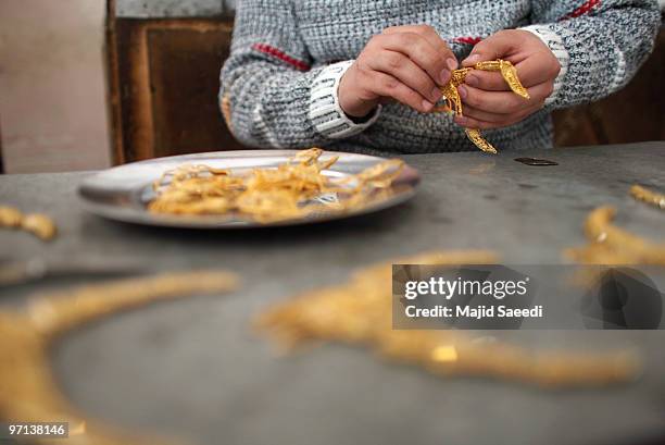 Gold pieces are seen in a jewelry shop February 27, 2010 in Herat, Afghanistan. As the ongoing war in Afghanistan enters its ninth year the...