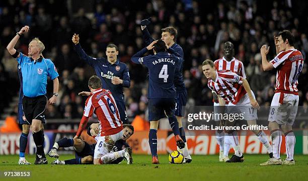 Aaron Ramsey of Arsenal lies seriously injured following a challenge by Ryan Shawcross of Stoke City during the Barclays Premier League match between...