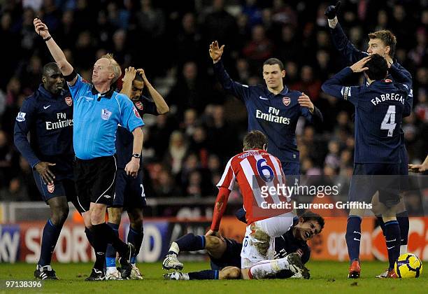 Aaron Ramsey of Arsenal lies seriously injured following a challenge by Ryan Shawcross of Stoke City during the Barclays Premier League match between...