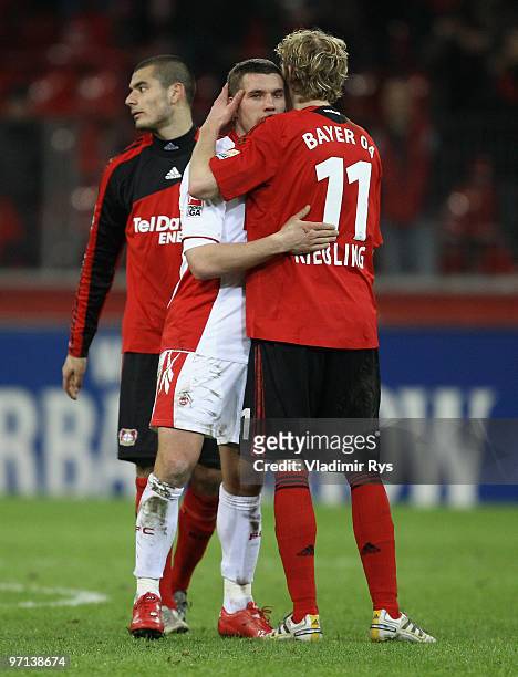 Eren Derdiyok , Stefan Kiessling of Leverkusen and Lukas Podolski of Koeln are pictured after the final whistle of the Bundesliga match between Bayer...