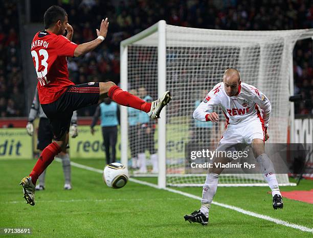 Miso Brecko of Koeln kicks away the ball in front of Arturo Vidal of Leverkusen during the Bundesliga match between Bayer Leverkusen and 1. FC Koeln...