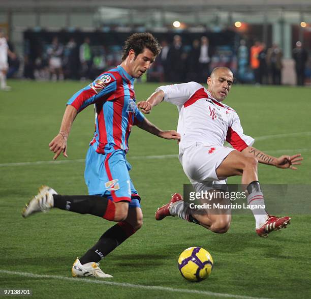 Mariano Izco of Catania Calcio battles for the ball with Sergio Almiron of AS Bari during the Serie A match between Catania and Bari at Stadio Angelo...