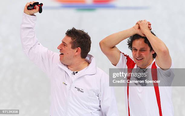 Markus Eggler and Ralph Stoeckli of Switzerland celebrate victory in the Men's Bronze Medal game between Sweden and Switzerland on day 16 of the 2010...