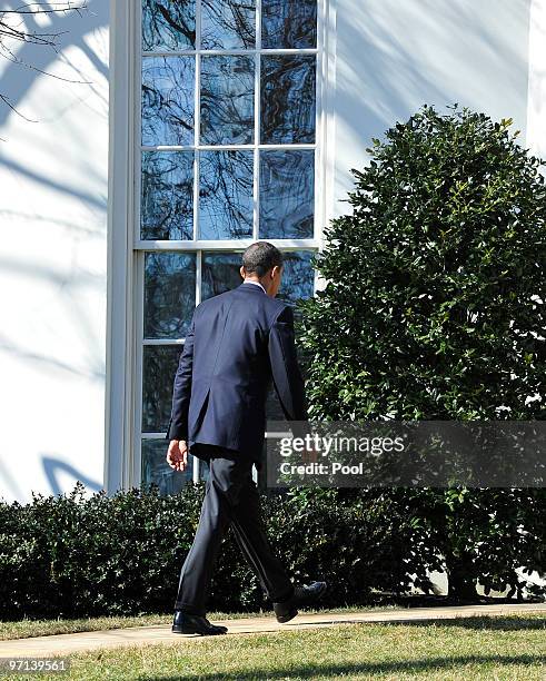 President Barack Obama returns to the Oval Office after addressing the media on the recent earthquake in Chile and a potentially damaging tsunami in...