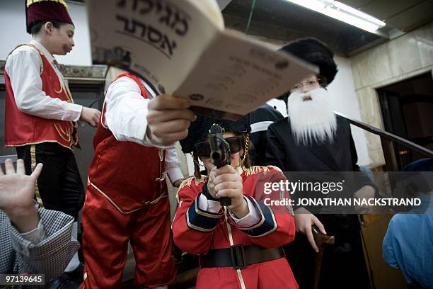 Children dressed in carnival costume play at a synagogue in the Israeli town of Bnei Brak, near Tel Aviv on February 27, 2010 during the feast of...