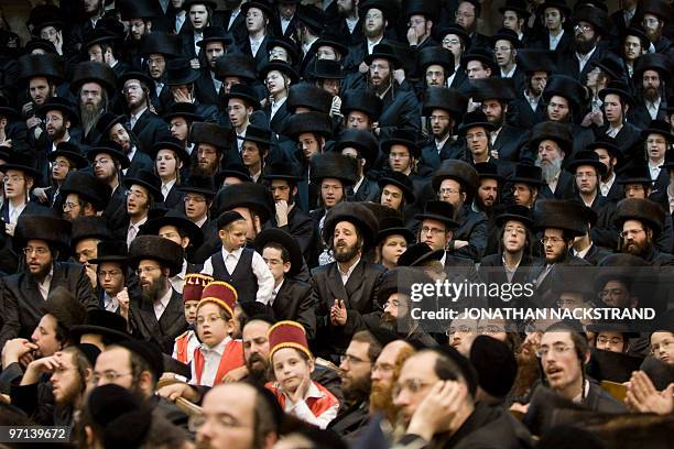 Ultra-Orthodox Jews belonging to the Vishnitz Hassidic sect sing after reading the Esther scrolls at a synagogue in the Israeli town of Bnei Brak,...