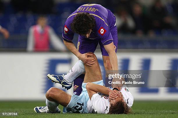 Stevan Jotevic of ACF Fiorentina helps Sebastiano Siviglia of SS Lazio after he was injured during the Serie A match between Lazio and Fiorentina at...