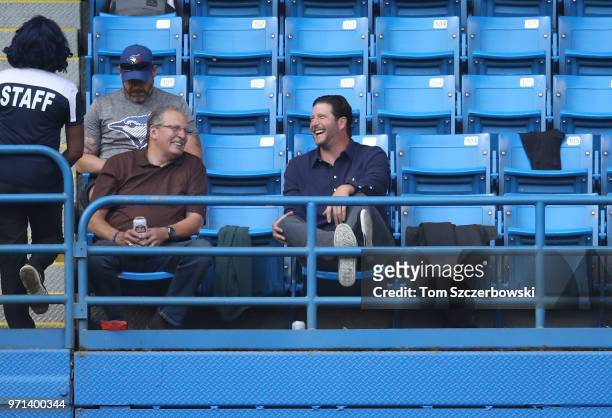 Former relief pitcher Jason Grilli watches the game from left field seats above the Toronto Blue Jays bullpen during MLB game action against the...