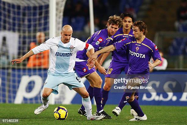 Tommaso Rocchi of SS Lazio and Mauro Bolatti, Felipe and Marco Donadel of ACF Fiorentina compete for the ball during the Serie A match between Lazio...