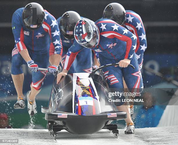 The USA-1 four-man bobsleigh team piloted by Steven Holcomb start heat 3 of the 4-man bobsleigh event at the Whistler sliding centre during the...
