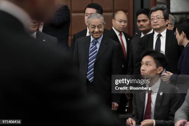 Mahathir Mohamad, Malaysia's prime minister, center, arrives for a news conference at the Japan National Press Club in Tokyo, Japan, on Monday, June...