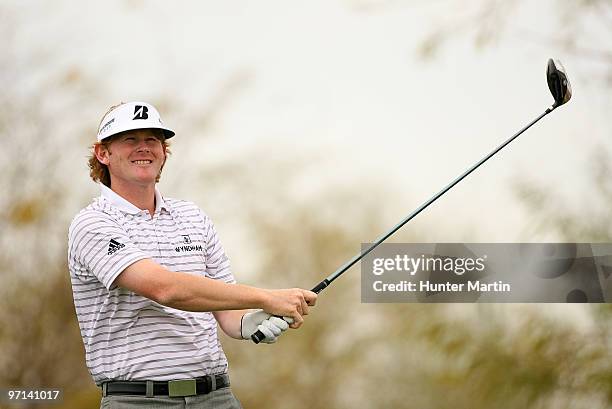 Brandt Snedeker watches his tee shot on the ninth hole during the third round of the Waste Management Phoenix Open at TPC Scottsdale on February 27,...
