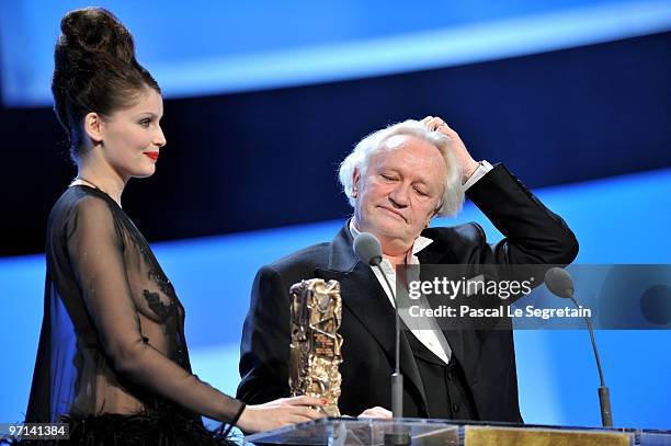 Niels Arelstrup reacts on stage as he receives Best Supporting Actor Cesar Award from Laetitia Casta during the 35th Cesar Film Awards at the Theatre...