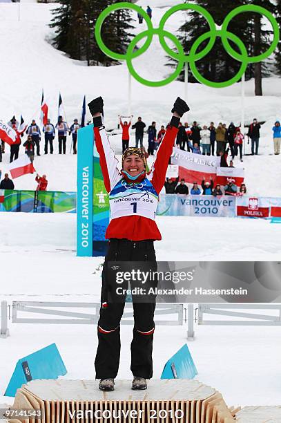 Justyna Kowalczyk of Poland celebrates winning the gold medal during the flower ceremony for the ladies' 30 km mass start cross-country skiing...