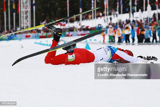 Justyna Kowalczyk of Poland reacts after crossing the finish line in first place during the ladies' 30 km mass start cross-country skiing classic on...