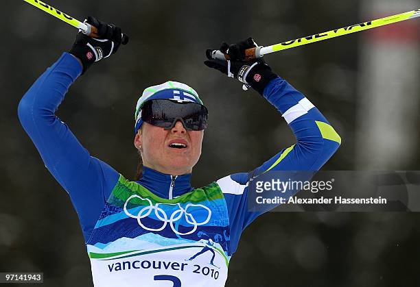Aino-Kaisa Saarinen of Finland celebrates winning the bronze medal in the ladies' 30 km mass start cross-country skiing classic on day 16 of the 2010...