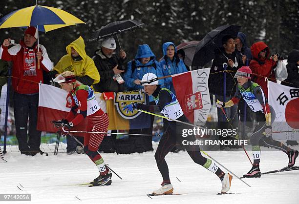 Norway's Therese Johaug, France's Karine Philippot -Laurent and Germany's Evi Sachenbacher-Stehle compete in the women's Cross Country skiing 30 km...