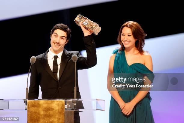 Actor Tahar Rahim reacts onstage after he received Best Male Revelation Cesar Award from Laura Smet during the 35th Cesar Film Awards held at Theatre...