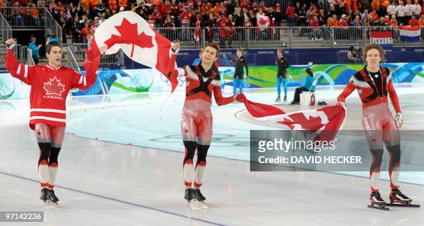 Gold medallists Canada's Denny Morrison, Lucas Makowsky and Mathieu Giroux celebrate after the Men's team pursuit speedskating final, at the Richmond...