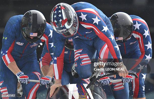 The USA-1 four-man bobsleigh team piloted by Steven Holcomb start heat 3 of the 4-man bobsleigh event at the Whistler sliding centre during the...