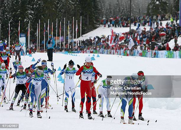 Aino Kaisa Saarinen of Finland leads the field after the start of the women's 30km mass start at the Olympic Winter Games Vancouver 2010 cross...