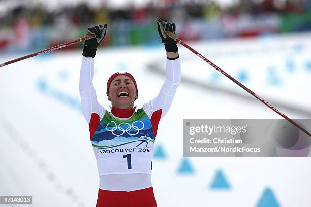 Justyna Kowalczyk of Poland celebrates her victory in the women's 30km mass start at the Olympic Winter Games Vancouver 2010 cross country on...