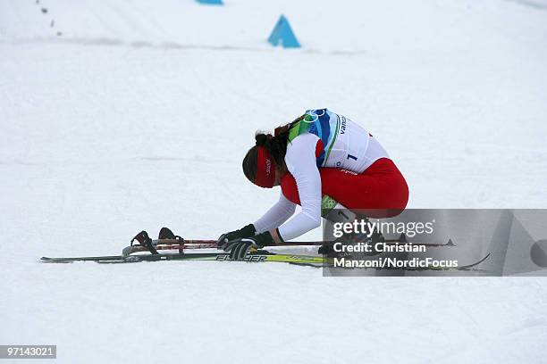 Justyna Kowalczyk of Poland falls on her knees after winning the gold medal in the women's 30km mass start at the Olympic Winter Games Vancouver 2010...