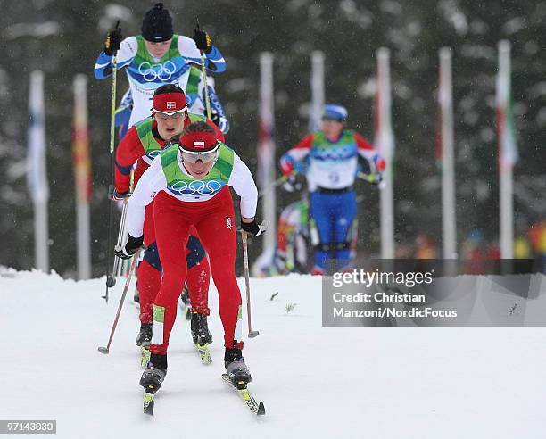 Justyna Kowalczyk of Poland leads Marit Bjoergen of Norway during the women's 30km mass start at the Olympic Winter Games Vancouver 2010 cross...