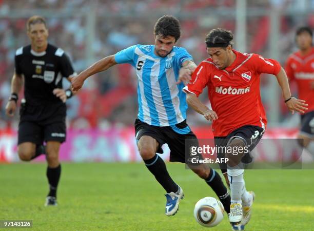 Independiente's defender Lucas Mareque vies for the ball with midfielder Claudio Yacob of Racing during their Argentina first division football match...