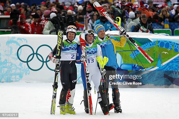 Ivica Kostelic of Croatia celebrates winning silver, Giuliano Razzoli of Italy gold and Andre Myhrer of Sweden bronze during the flower ceremony for...