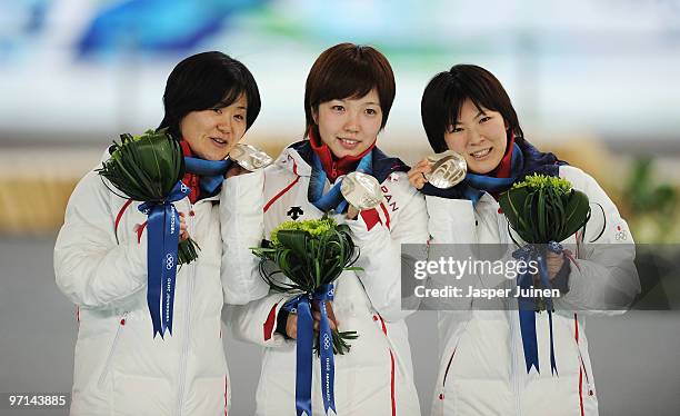 Maki Tabata, Nao Kodaira and Masako Hozumi of Japan celebrate winning the silver medal in the ladies' team pursuit final on day 16 of the 2010...