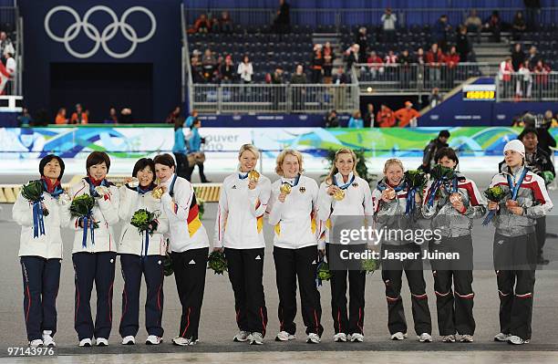 Team Japan celebrate silver, Team Germany celebrate gold and Team Poland bronze during the medal ceremony for the ladies' team pursuit final on day...