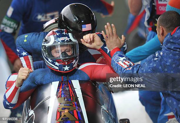 The USA-1 four-man bobsleigh team piloted by Steven Holcomb celebrates winning gold in the 4-man bobsleigh event at the Whistler sliding centre...