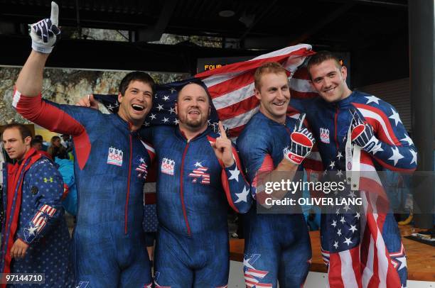 Steve Mesler, Steven Holcomb, Curtis Tomasevicz and Justin Olsen of the USA-1 four-man bobsleigh team celebrate winning gold in the 4-man bobsleigh...