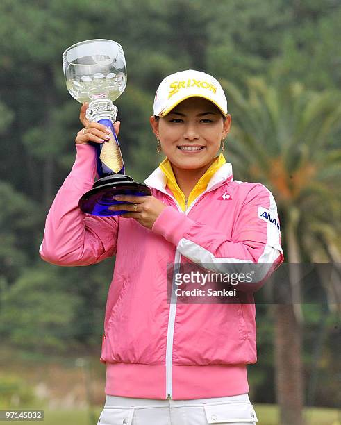 Sakura Yokomine poses for photographs with the trophy after winning the LPGA Tour Championship Ricoh Cup at Miyazaki Country Club on November 28,...